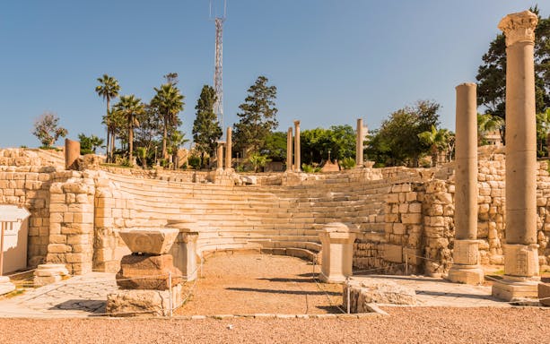 Roman amphitheater ruins in Alexandria, Egypt, with stone columns and seating.