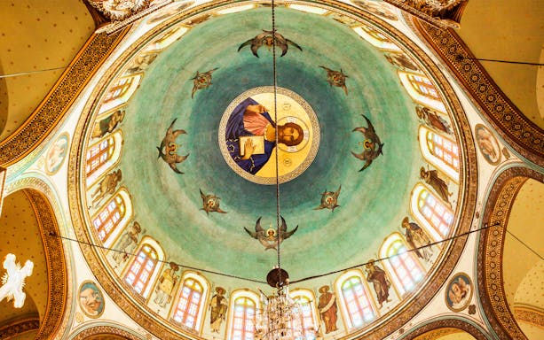 Dome artwork in a Coptic church, Cairo, featuring religious figures and intricate designs.
