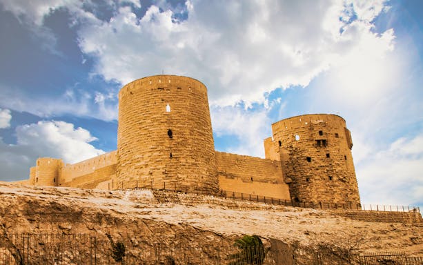 Citadel of Saladin in Cairo under a blue sky.