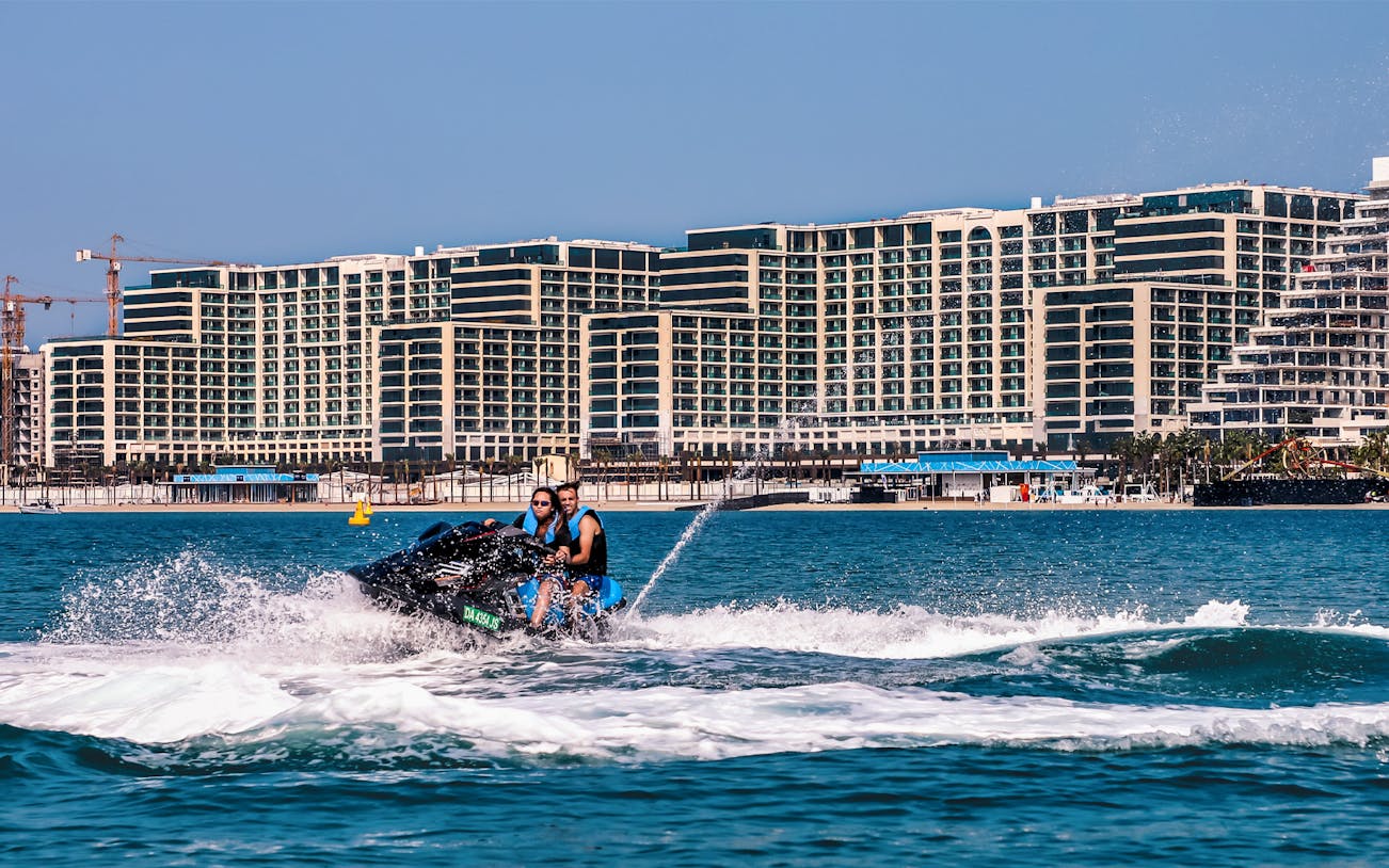 Jet ski ride on the Red Sea with cityscape backdrop, part of a full-day trip from Cairo.