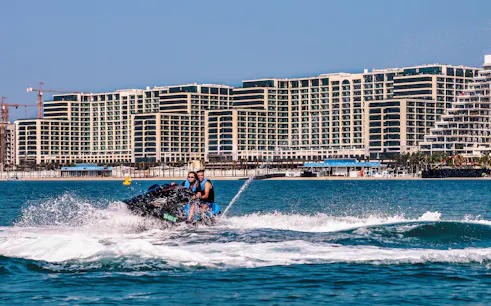 Jet ski ride on the Red Sea with cityscape backdrop, part of a full-day trip from Cairo.