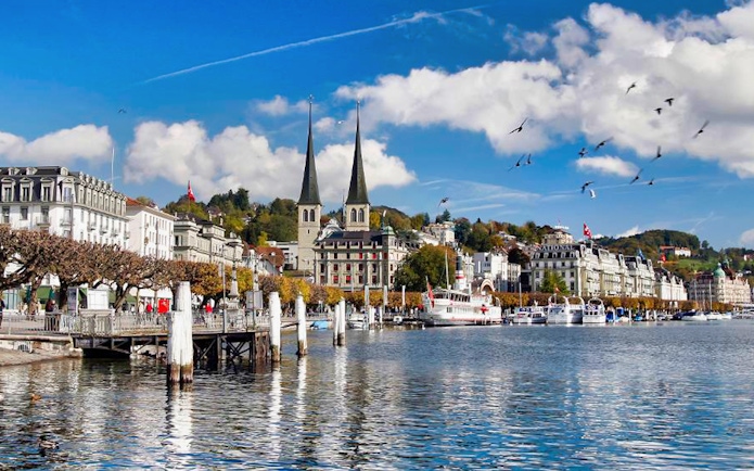 Lucerne waterfront with Chapel Bridge and twin towers of Church of St. Leodegar, Switzerland.