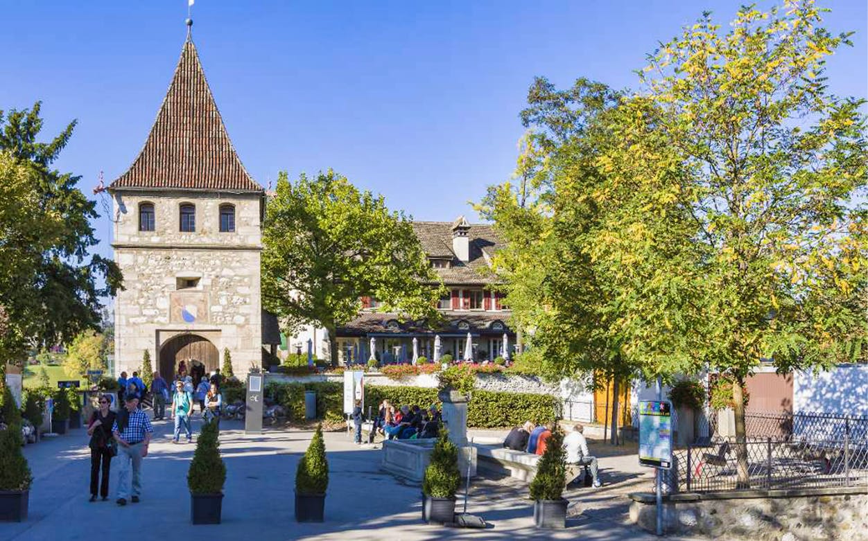 Laufen Castle entrance with visitors, part of the 4-hour guided tour from Zürich to Rhine Falls.