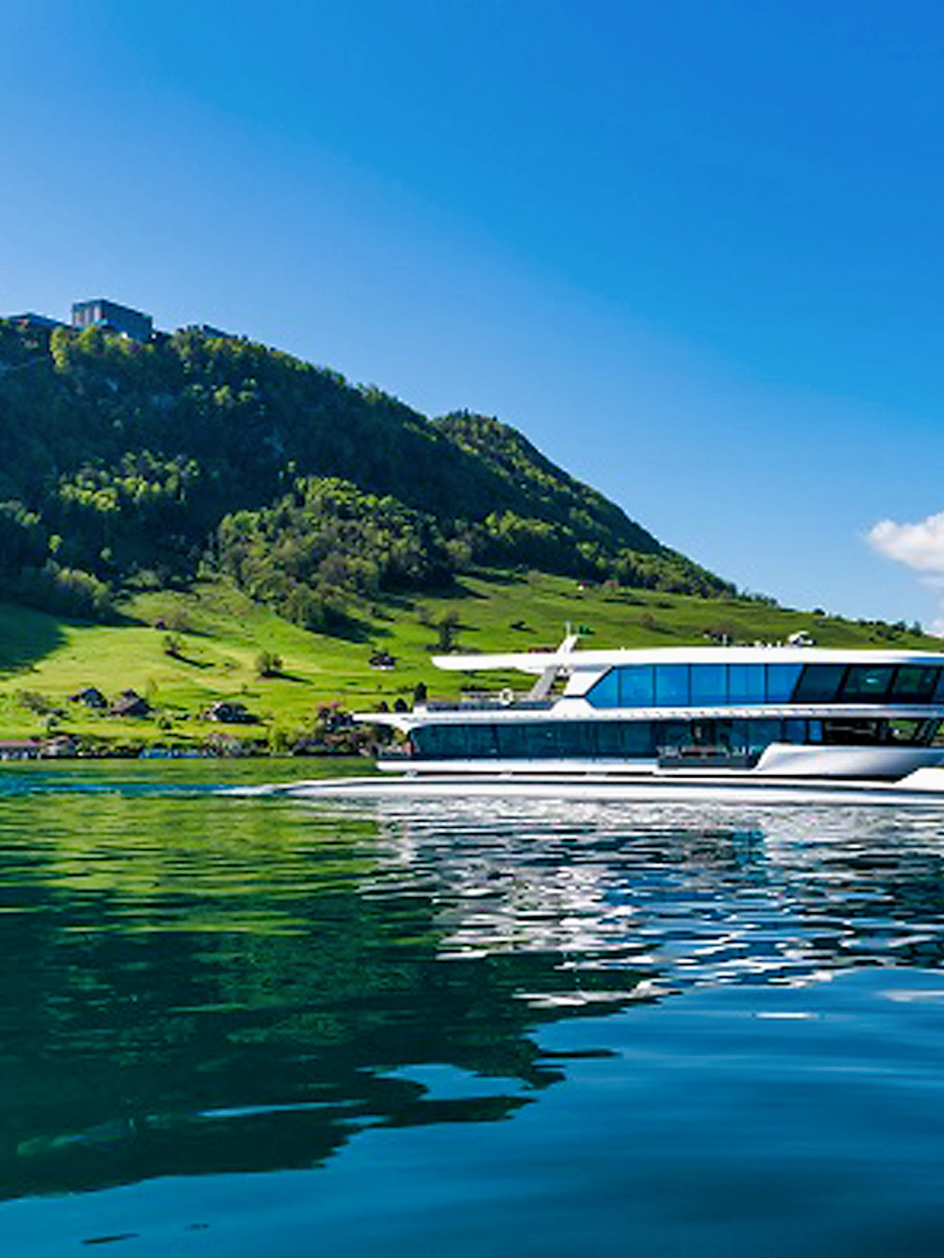 Boat cruising on Lake Lucerne with Mt. Bürgenstock in the background, Switzerland.