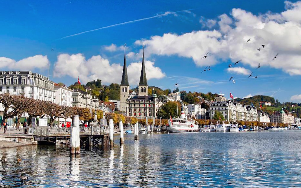 Lake Lucerne waterfront with historic buildings and boats, view from day trip to Mt. Bürgenstock.