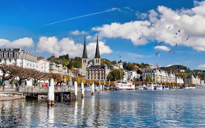Lake Lucerne waterfront with historic buildings and boats, view from day trip to Mt. Bürgenstock.
