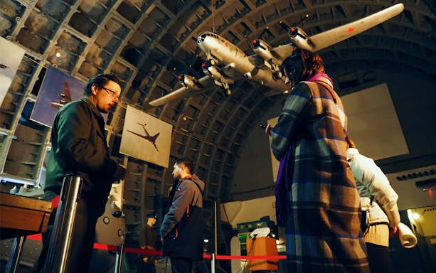 Visitors exploring aircraft exhibits at Bunker 42 Cold War Museum in Moscow.