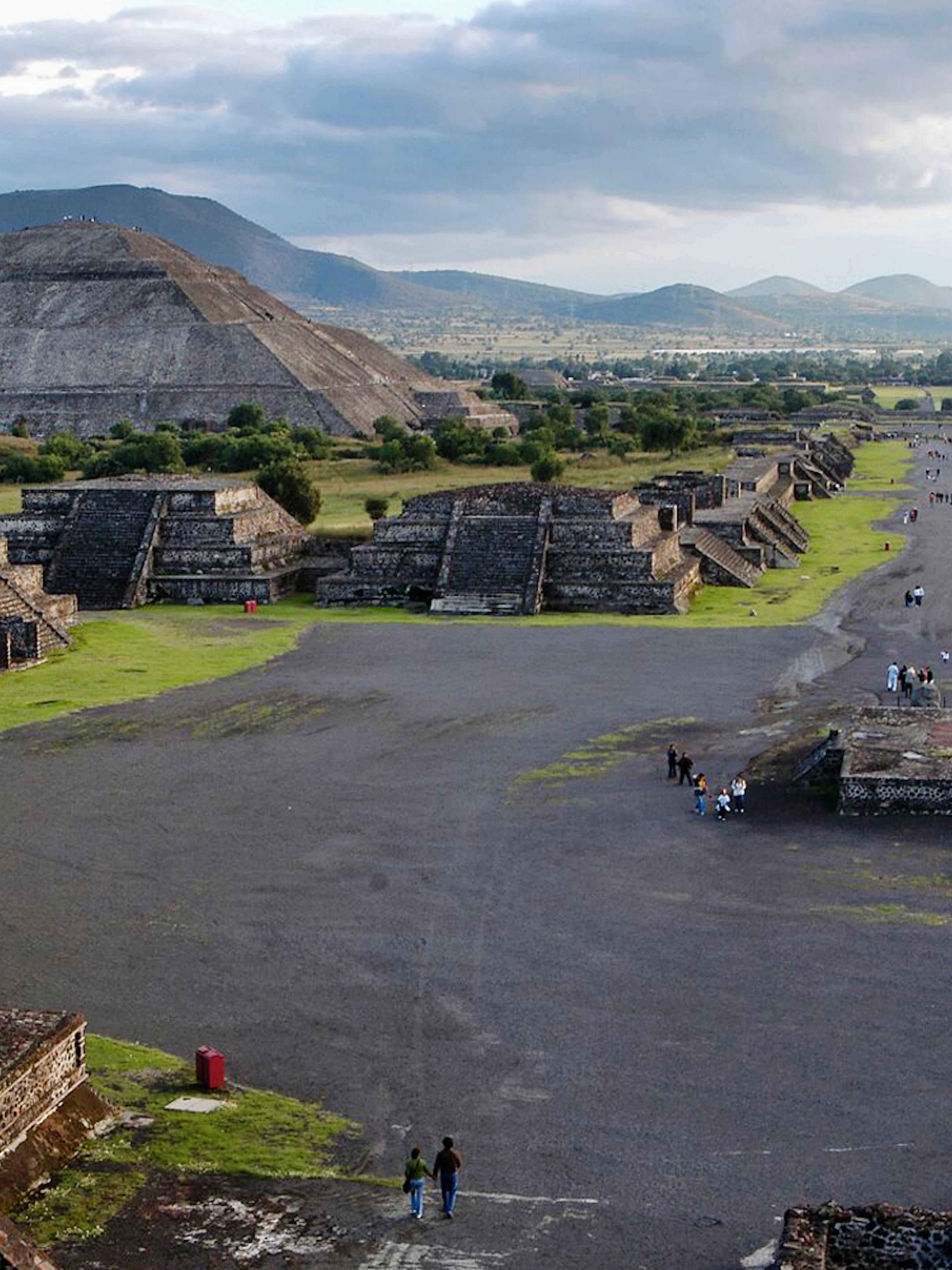 Teotihuacan pyramids and Avenue of the Dead with visitors exploring the ancient site in Mexico.