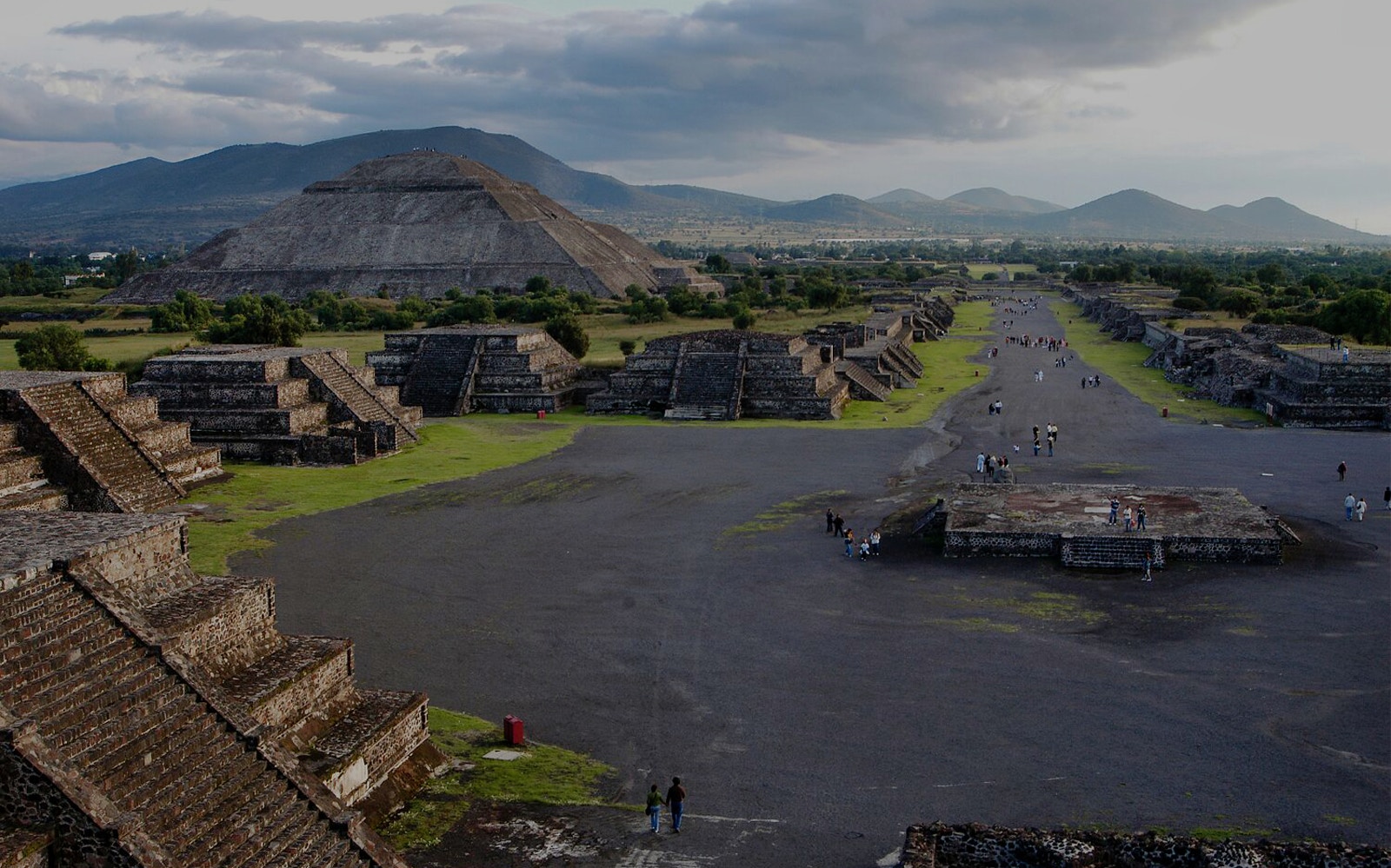 Teotihuacan pyramids and Avenue of the Dead with visitors exploring the ancient site in Mexico.