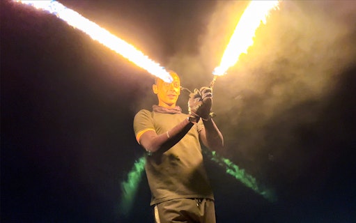 Fire performer during desert safari entertainment at night.