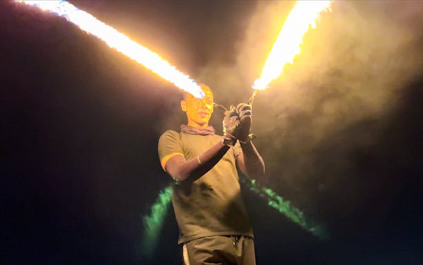 Fire performer during desert safari entertainment at night.