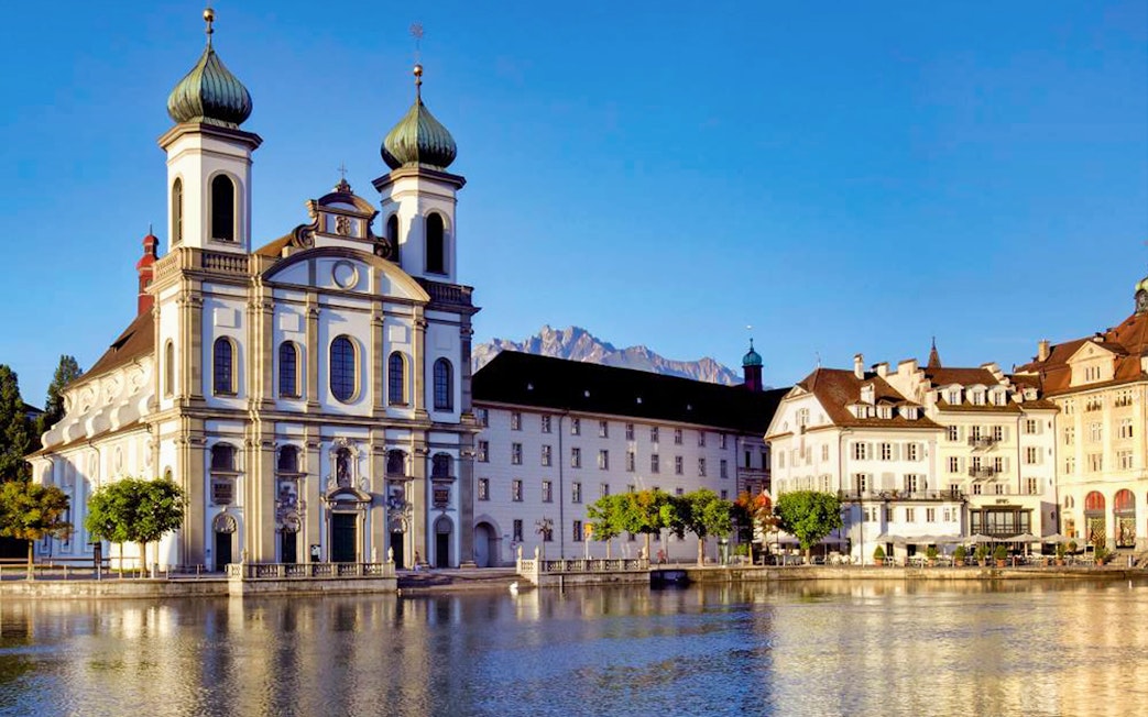 Jesuit Church in Lucerne by the Reuss River, seen on a day trip from Zürich with yacht cruise.