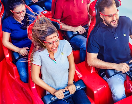 Visitors enjoying a roller coaster ride at Ferrari World Abu Dhabi.