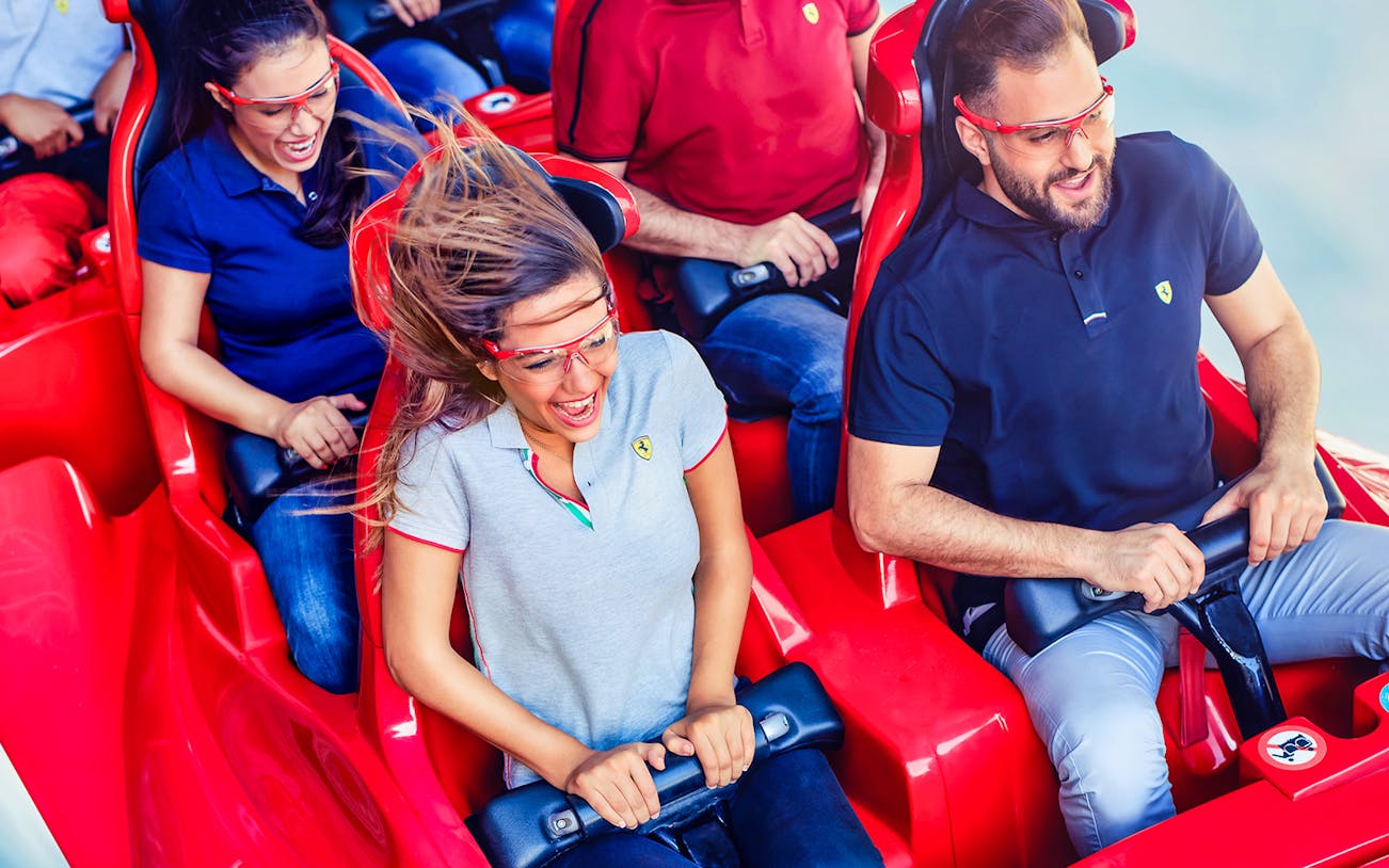 Visitors enjoying a roller coaster ride at Ferrari World Abu Dhabi.