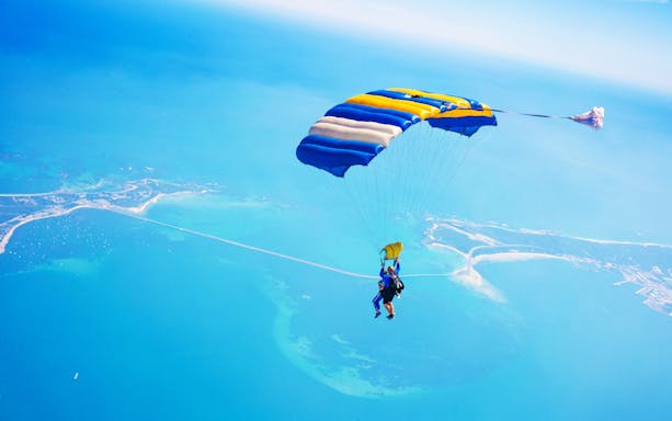 Skydivers descending over Rockingham coastline, Perth, from 15,000 feet.