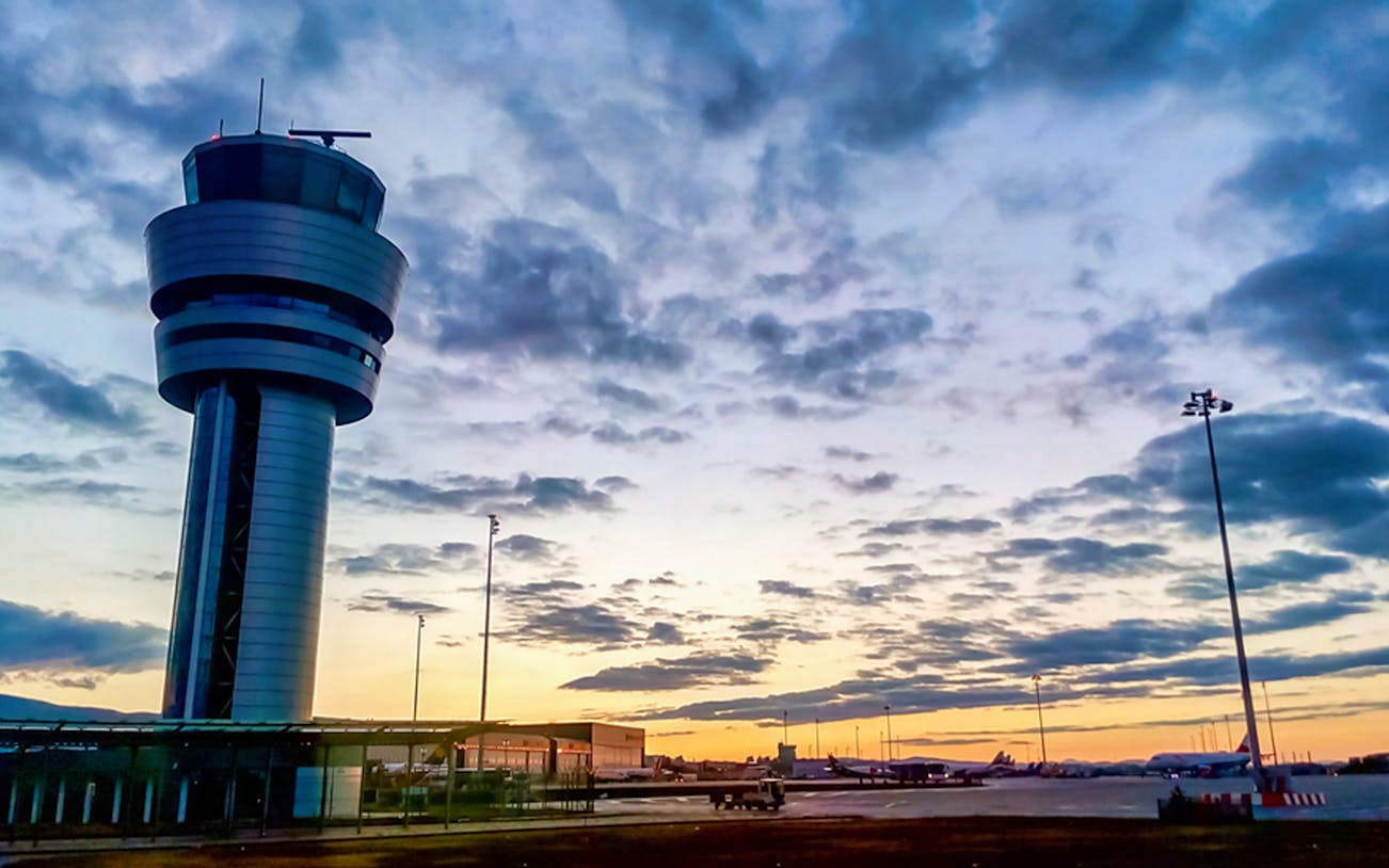 Airport control tower at sunset, Bucharest round-trip airport transfers.
