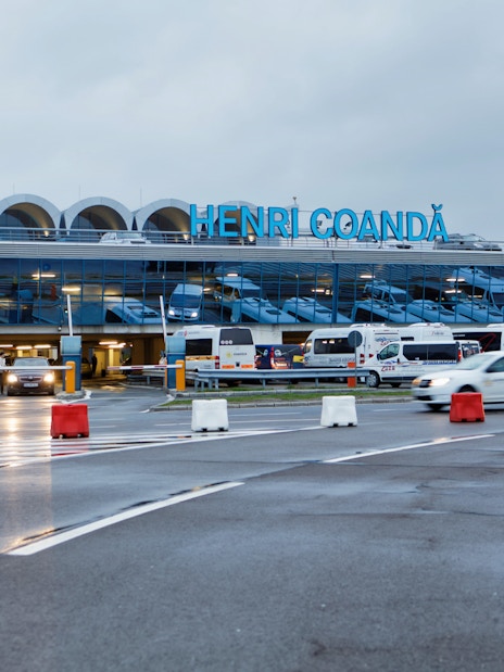 Henri Coandă Airport entrance with cars and buses, Bucharest airport transfer.