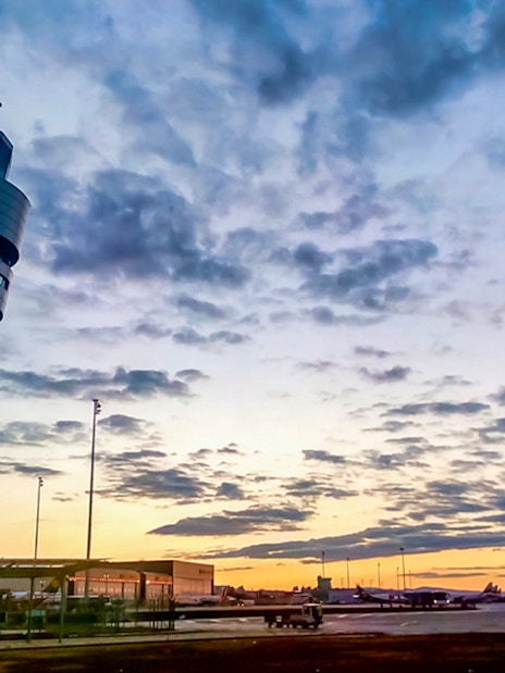 Control tower at Henri Coandă Airport during sunset, Bucharest.