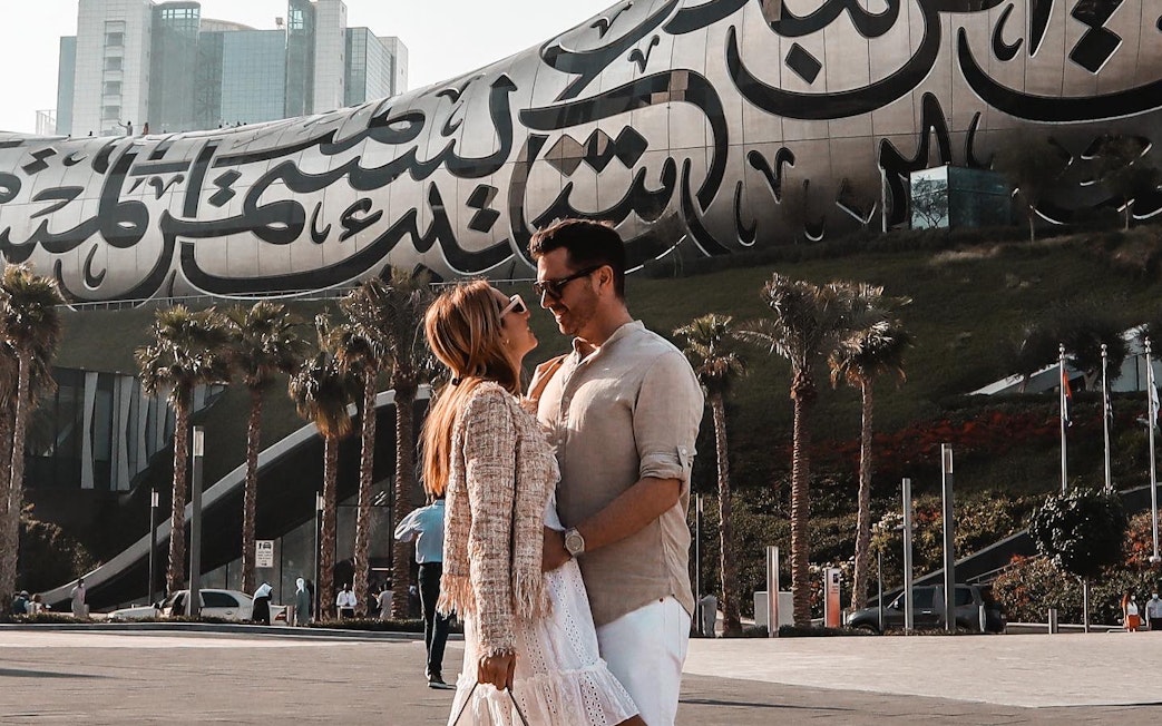 Couple in front of the Museum of the Future, Dubai, part of IMG Worlds combo offer.