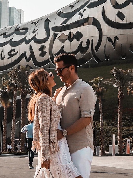 Couple in front of the Museum of the Future, Dubai, part of IMG Worlds combo offer.