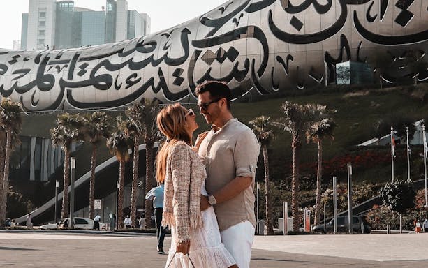 Couple in front of the Museum of the Future, Dubai, part of IMG Worlds combo offer.