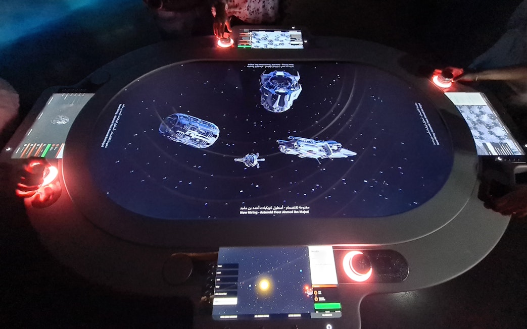 Interactive space-themed exhibit at Museum of the Future, Dubai, with digital controls and spacecraft visuals.