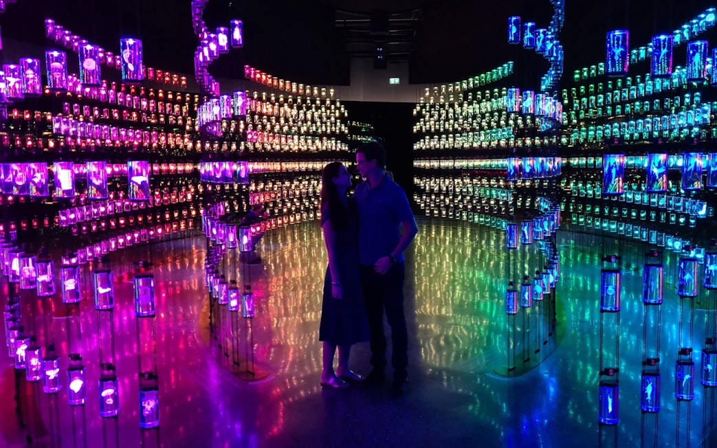 Visitors inside a colorful, illuminated exhibit at the Museum of the Future, Dubai.