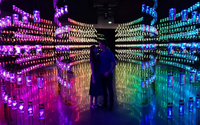 Visitors inside a colorful, illuminated exhibit at the Museum of the Future, Dubai.