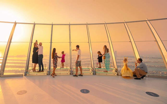 Visitors enjoying sunset views from The View at The Palm, Dubai.