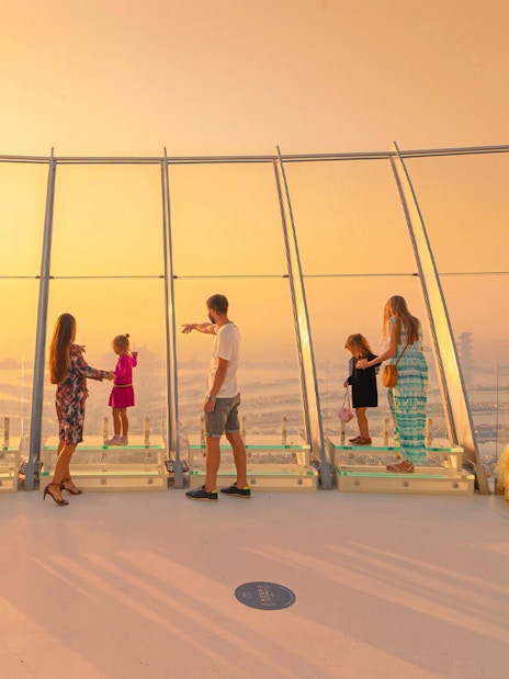 Visitors enjoying sunset views from The View at The Palm, Dubai.