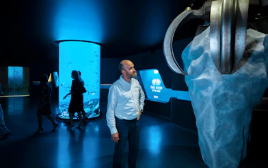 Man observing exhibit at IMG Worlds of Adventure with The View at The Palm display.