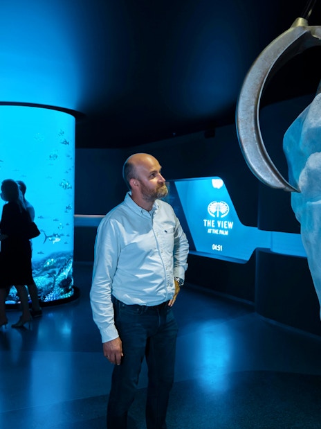 Man observing exhibit at IMG Worlds of Adventure with The View at The Palm display.