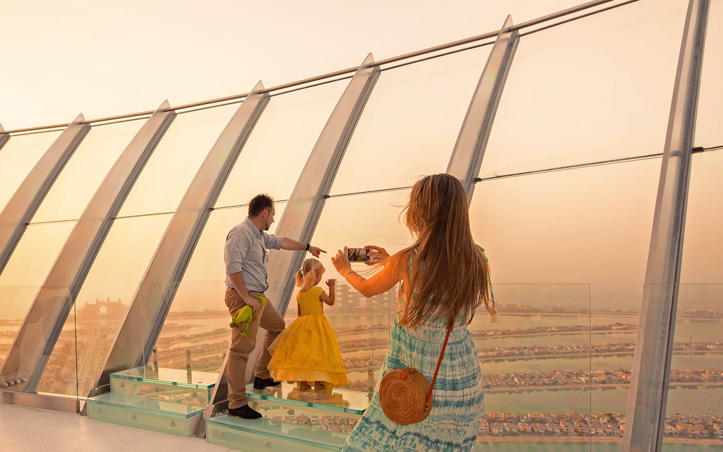 Family enjoying panoramic view from The View at The Palm, Dubai.
