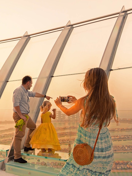 Family enjoying panoramic view from The View at The Palm, Dubai.