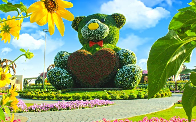 Giant floral teddy bear sculpture at Dubai Miracle Garden.