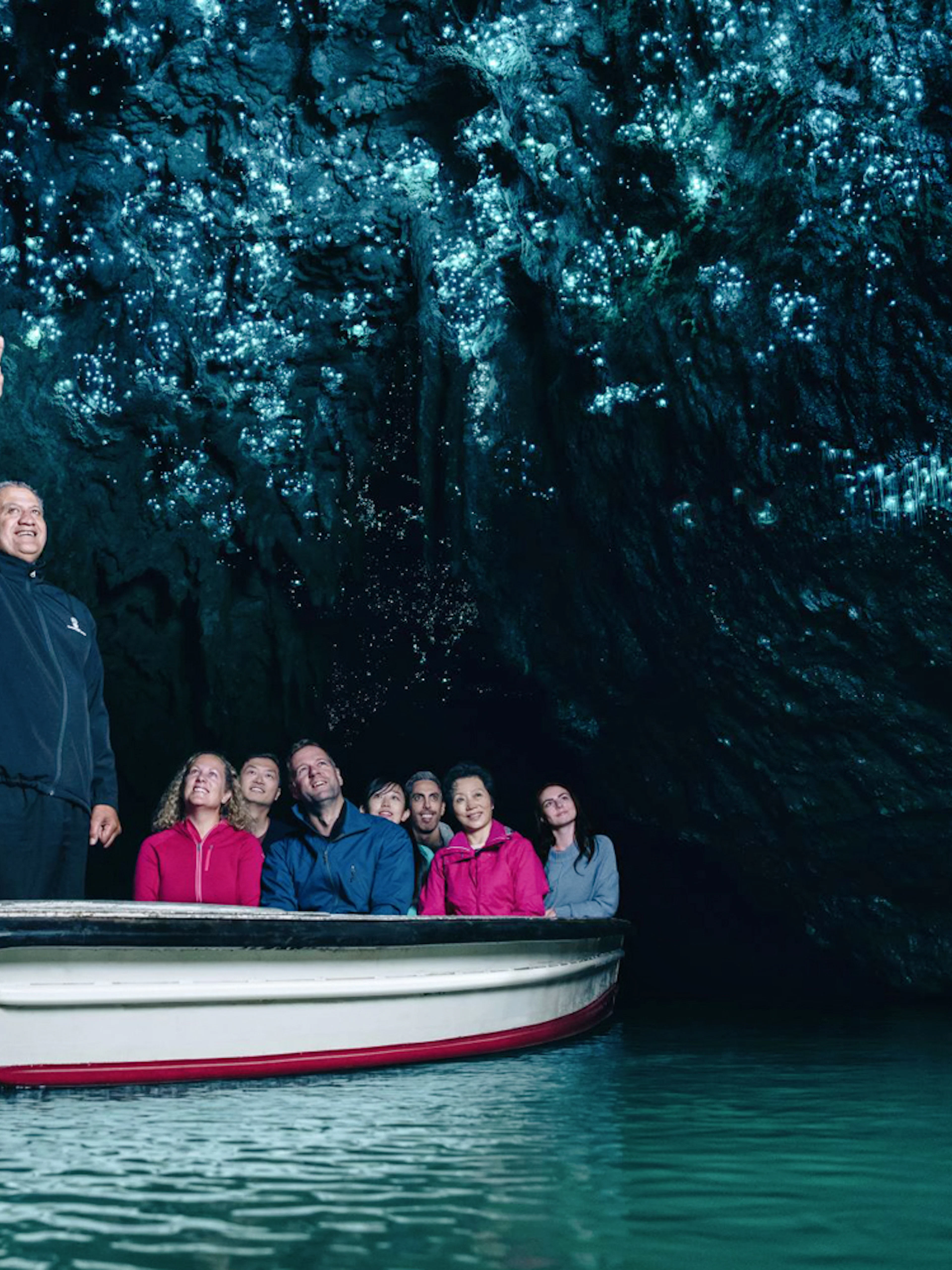 Boat tour under glowworms in Waitomo Caves, New Zealand.