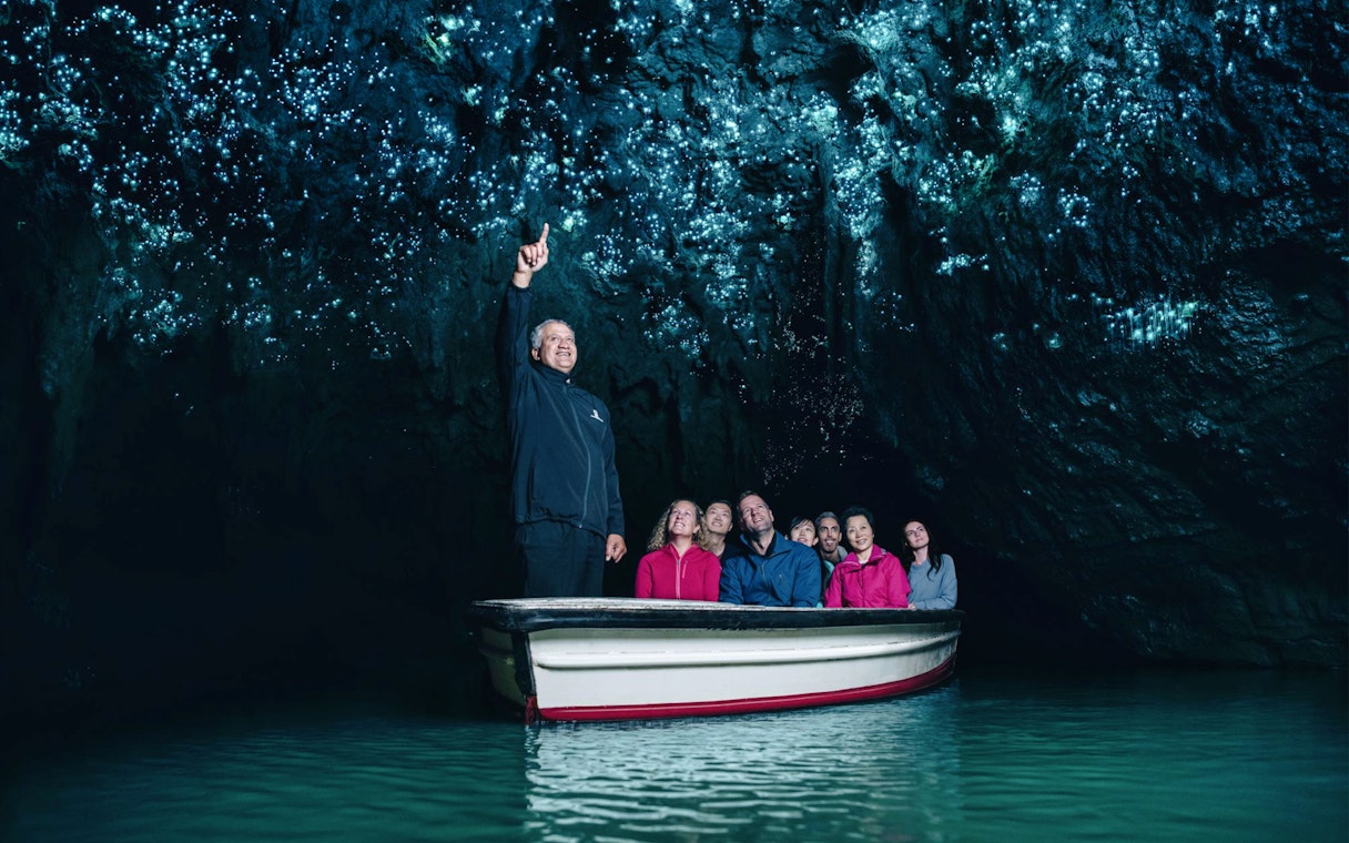 Boat tour under glowworms in Waitomo Caves, New Zealand.