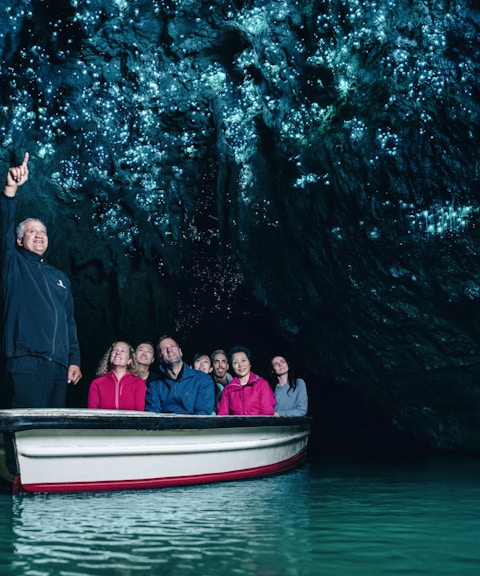 Boat tour under glowworms in Waitomo Caves, New Zealand.