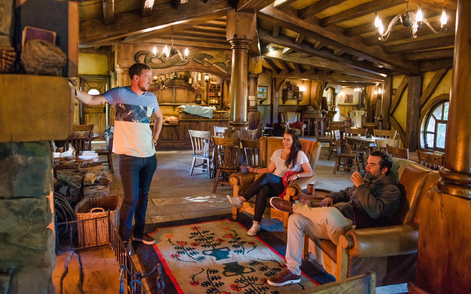Visitors relaxing inside the Green Dragon Inn at Hobbiton Movie Set, New Zealand.