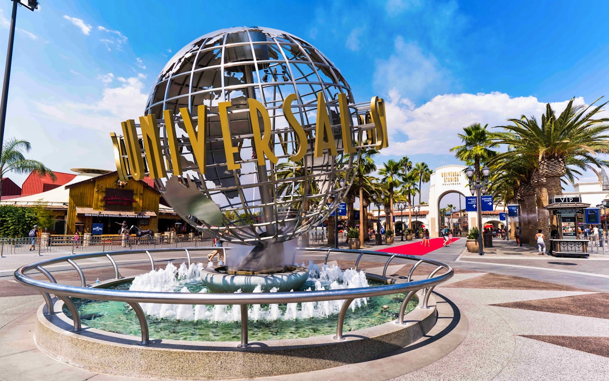 Universal Studios Hollywood entrance with iconic globe and fountain.