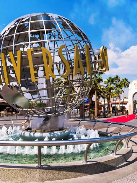 Universal Studios Hollywood entrance with iconic globe and fountain.