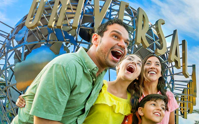 Family enjoying Universal Studios Hollywood entrance globe.