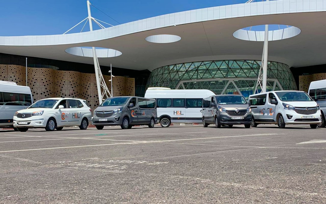 Airport transfer vehicles parked outside Marrakesh terminal for Essaouira private transfers.