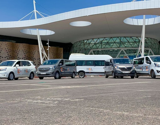 Ourika private transfer vehicles parked at Marrakesh airport.