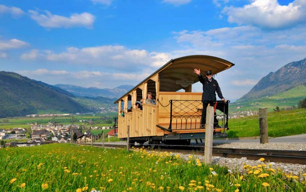Open-top cable car on Mt. Stanserhorn with scenic mountain views in Switzerland.