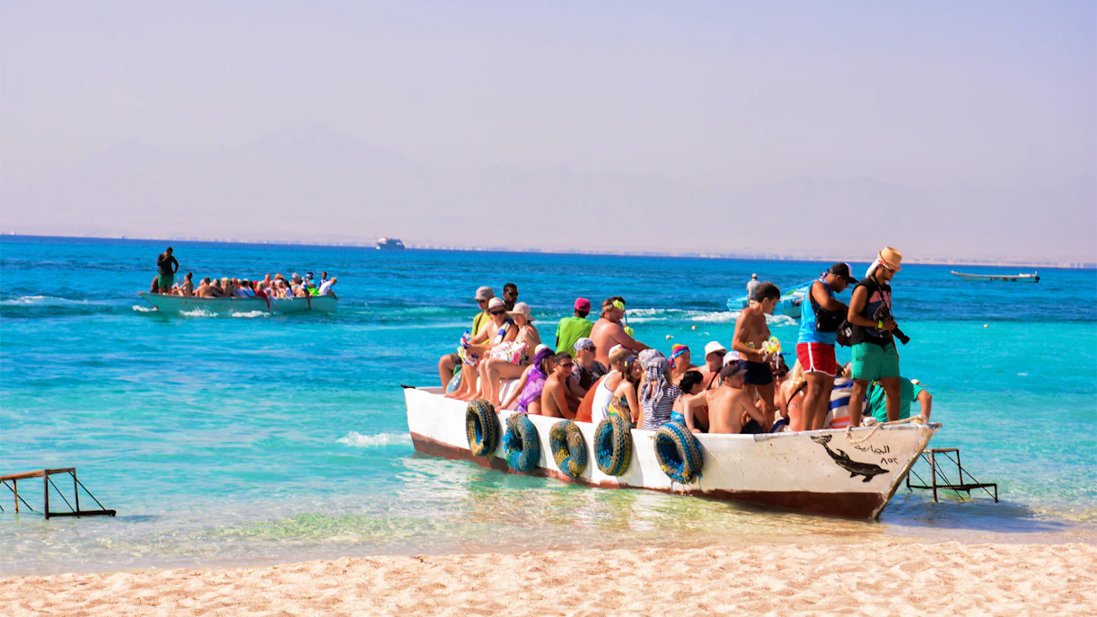 Tourists on a boat arriving at Giftun Island, Egypt, during a half-day tour with lunch.
