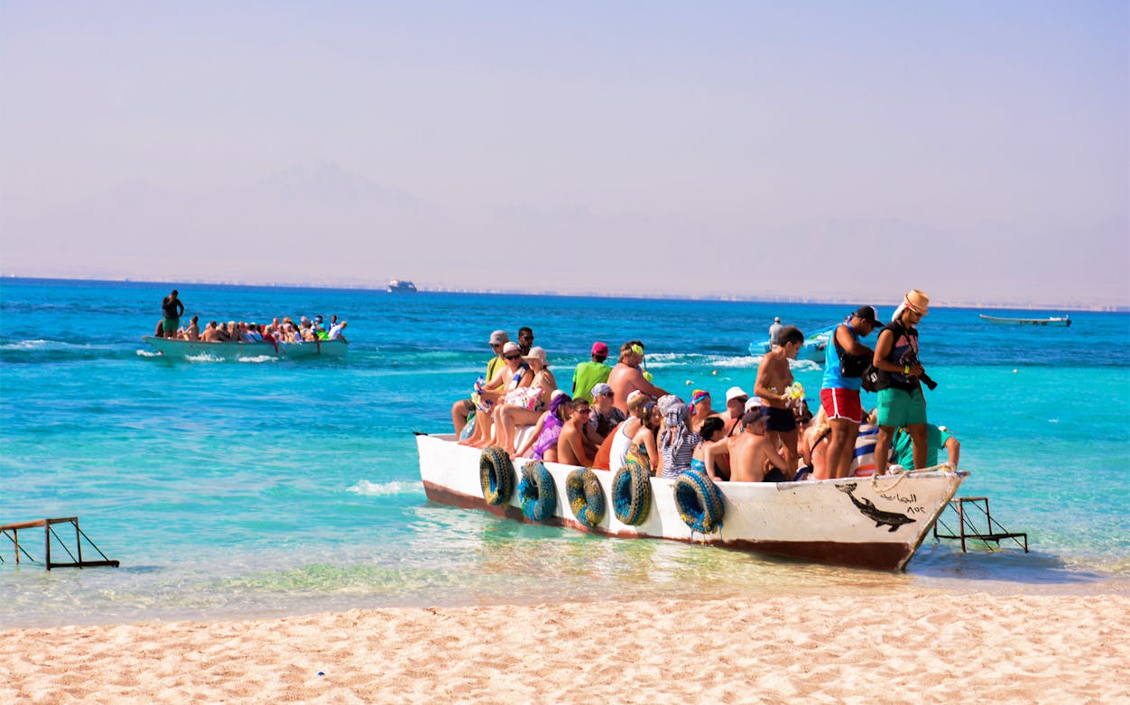 Tourists on a boat arriving at Giftun Island, Egypt, during a half-day tour with lunch.