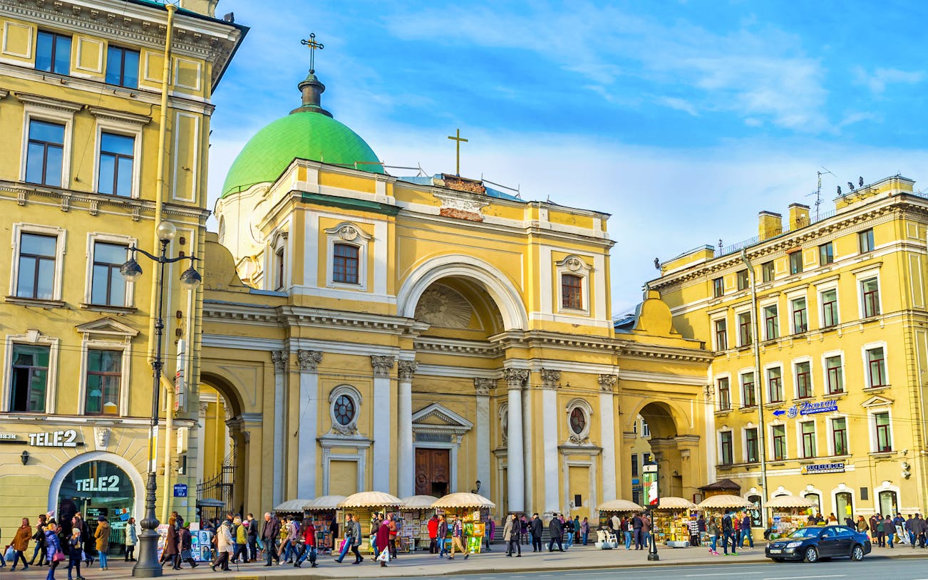 Shrine on Nevsky Prospekt with green dome and street vendors, St. Petersburg.
