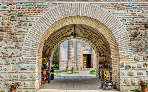 Stone archway leading to a historic building in Bucharest on a private tour.
