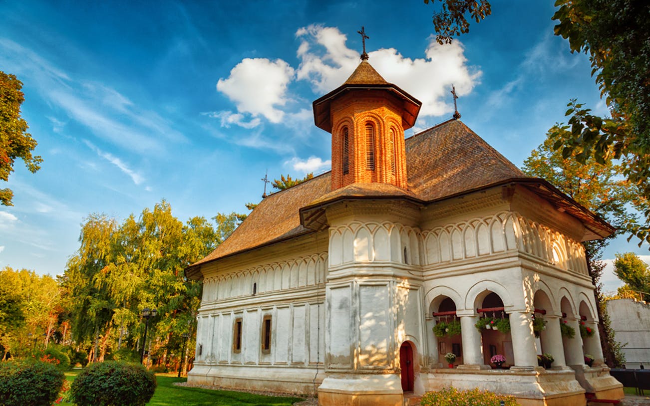 Historic church in Bucharest surrounded by lush greenery on a half-day private tour.